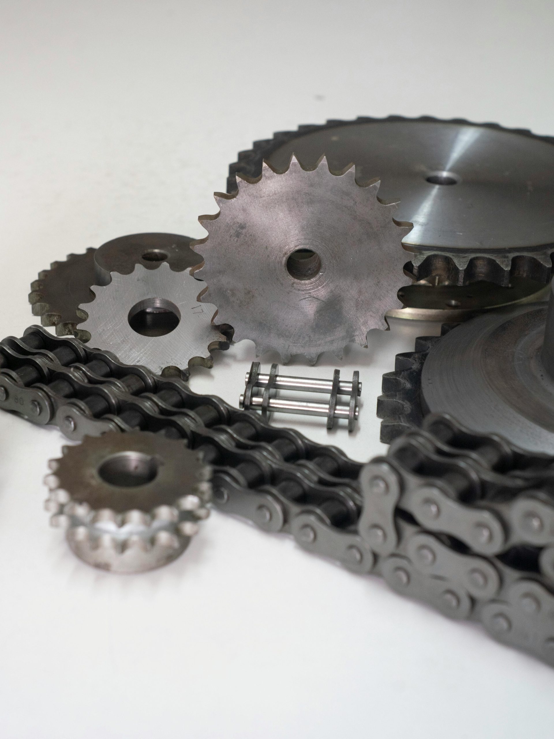 Close-up of metal gears and chains showcasing industrial engineering parts.